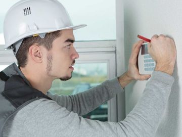 An expert installing a Burglar Alarm