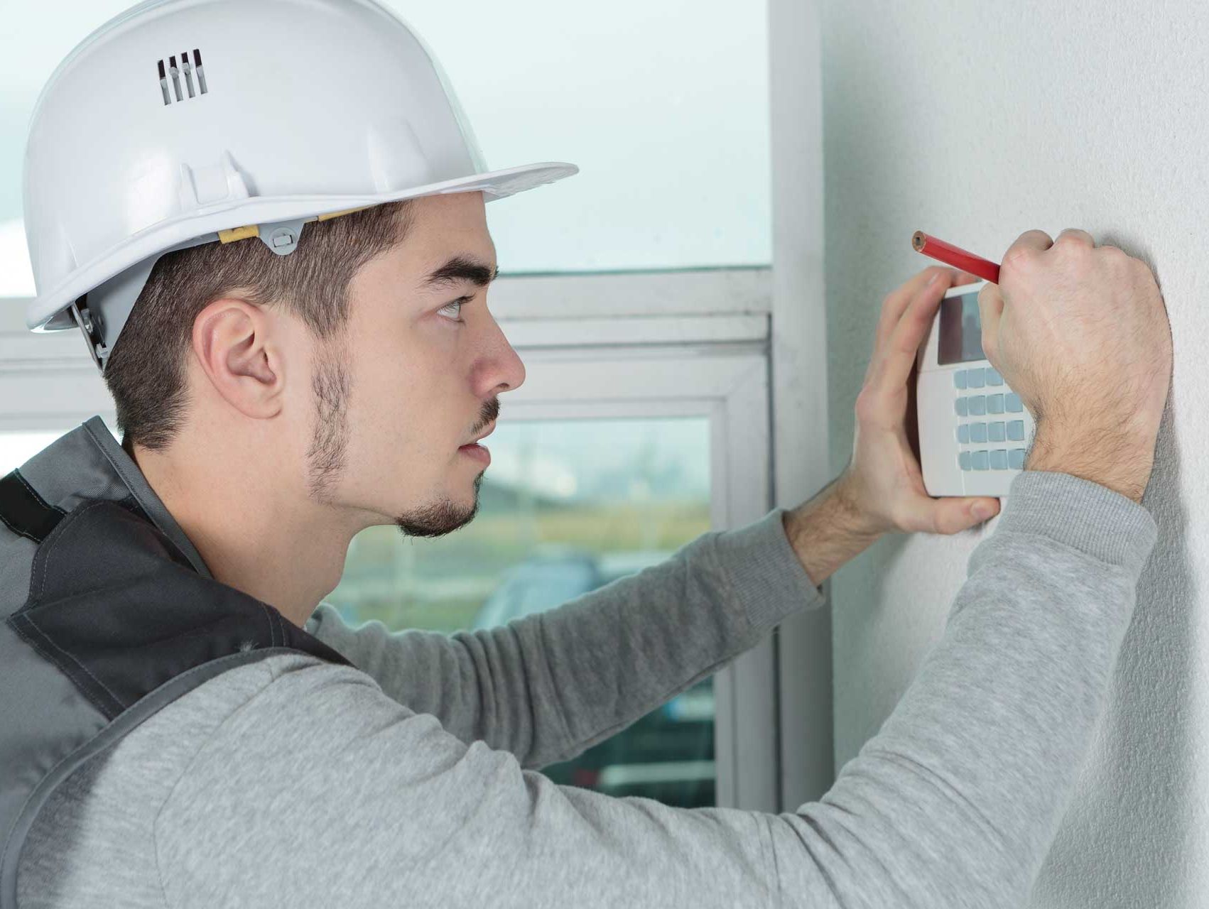 An expert installing a Burglar Alarm